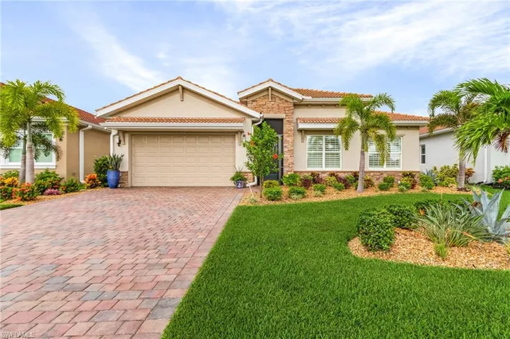 View of front of property featuring a front yard and a garage