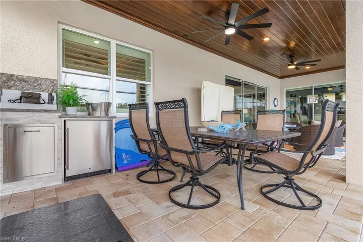 View of patio / terrace with ceiling fan and exterior kitchen