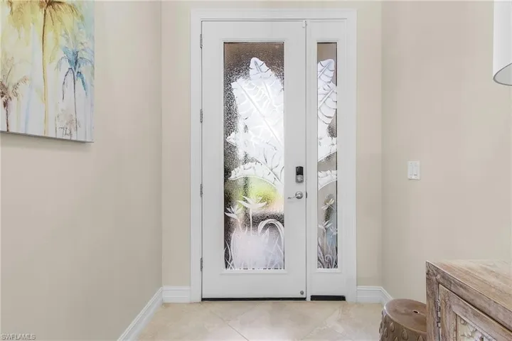 Entrance foyer with light tile patterned floors