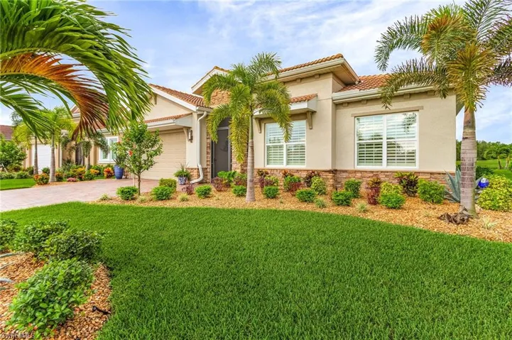 Mediterranean / spanish-style house with a front yard and a garage