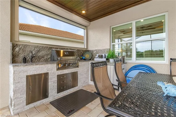 View of patio / terrace featuring sink, a grill, and an outdoor kitchen