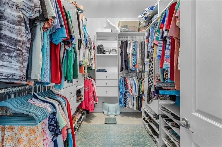 Walk in closet featuring light tile patterned flooring