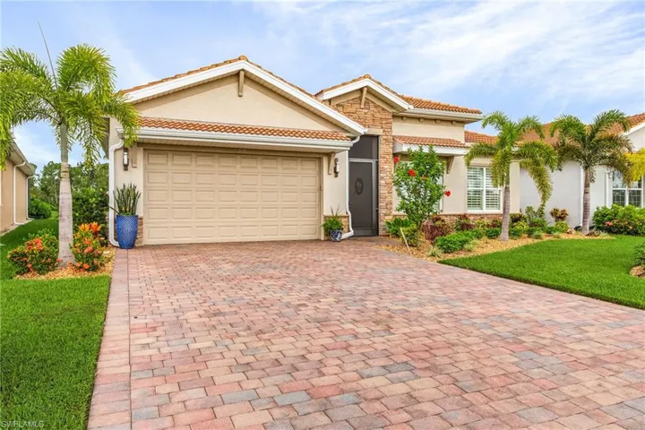 Mediterranean / spanish-style house featuring a front yard and a garage