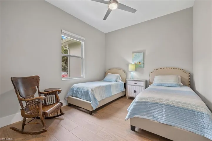 Bedroom with ceiling fan and light wood-type flooring