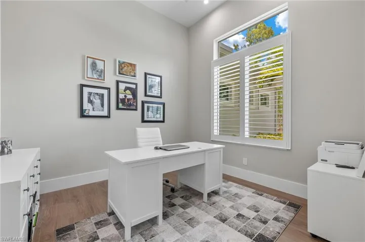Office with light hardwood / wood-style flooring