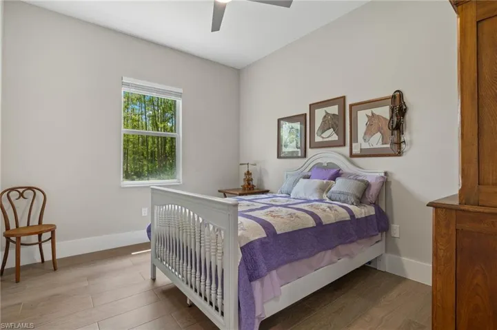 Bedroom with wood-type flooring and ceiling fan