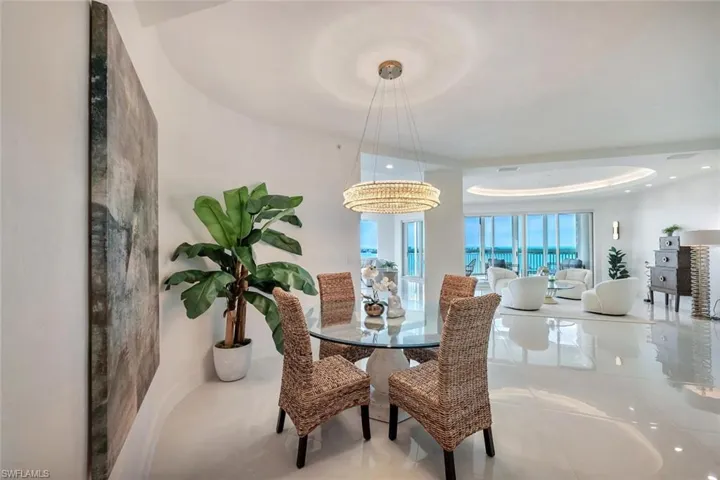 Dining space featuring gorgeous light fixture and tray ceiling