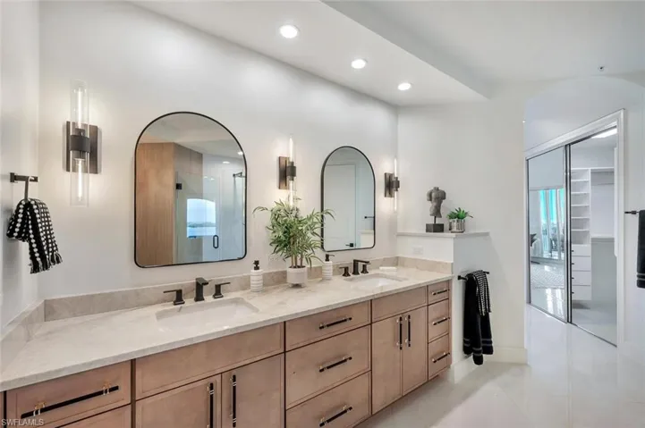 Master bath with beautiful custom tile shower, double vanity,  custom lighting