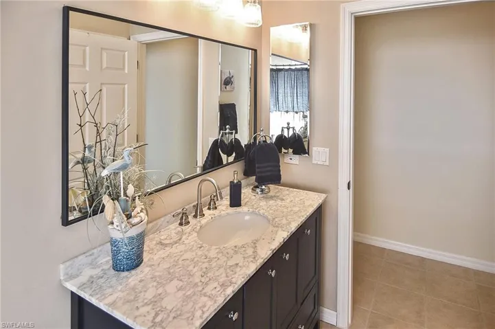 Bathroom featuring vanity and light tile patterned flooring