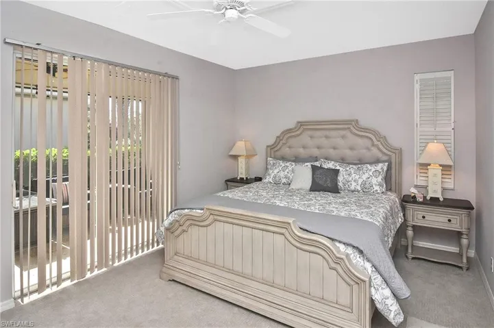 Bedroom with access to exterior, light colored carpet, and ceiling fan