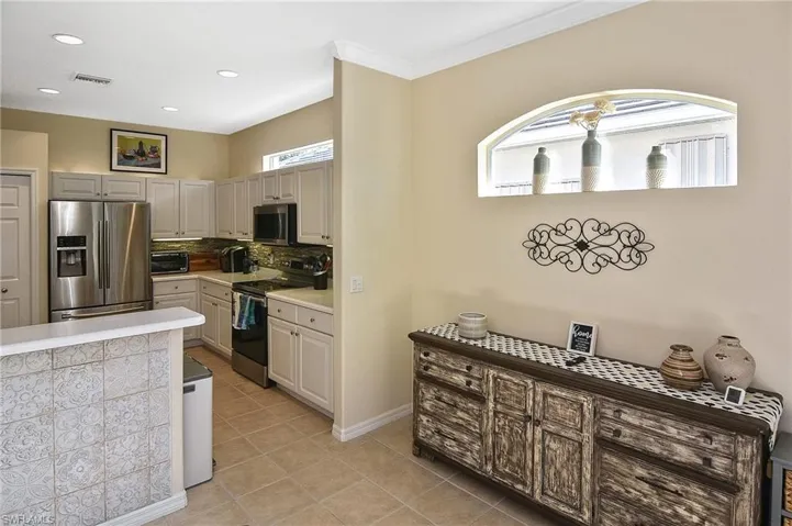 Kitchen with appliances with stainless steel finishes, plenty of natural light, backsplash, light countertops, and recessed lighting