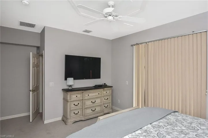 Bedroom featuring light carpet and ceiling fan