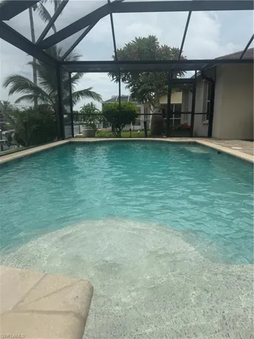 Outdoor pool featuring glass enclosure