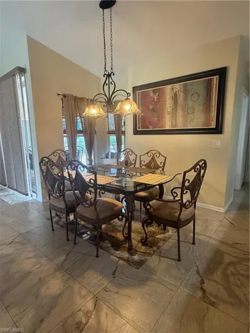 Dining room with vaulted ceiling and baseboards