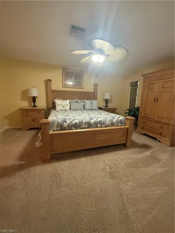 Bedroom featuring light colored carpet and a ceiling fan