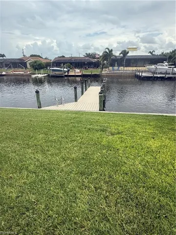 Dock area featuring a yard and a water view