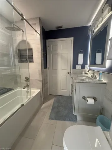 Full bathroom featuring vanity and washtub / shower combination