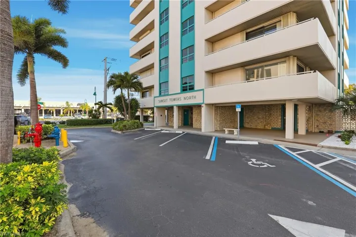 View of building exterior with uncovered parking