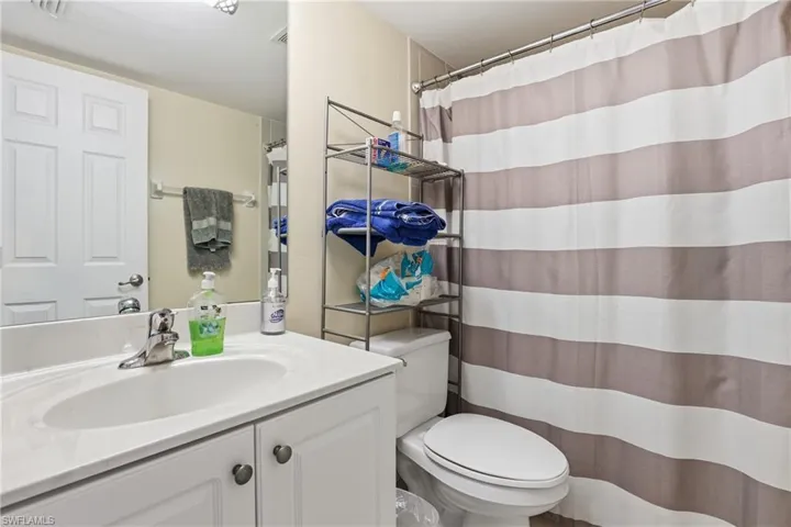 Full bathroom featuring a shower with curtain and vanity