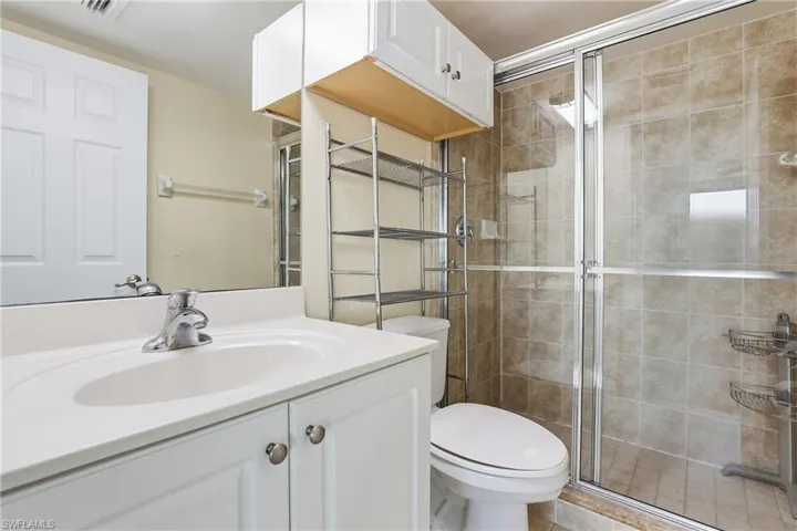 Full bathroom featuring vanity and a stall shower