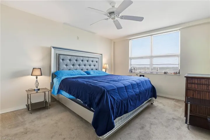 Bedroom featuring ceiling fan and carpet floors