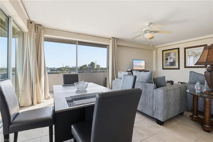 Dining area featuring light tile patterned floors and ceiling fan
