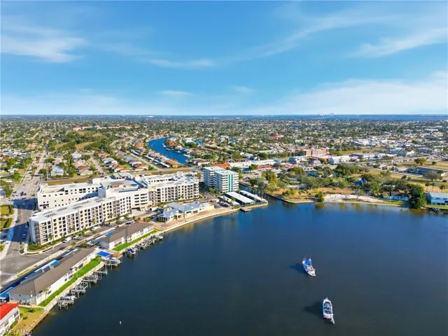 Drone / aerial view of a nearby body of water and apartment complex