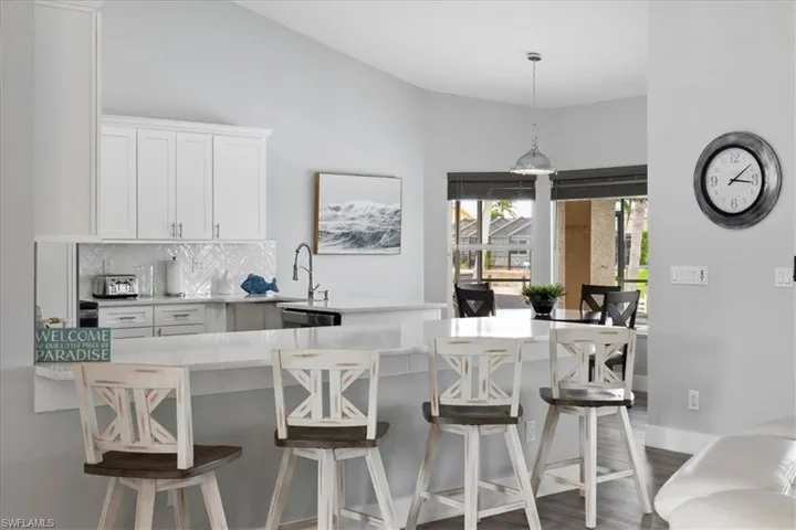 Very Spacious Kitchen featuring a breakfast bar, high-end white cabinets and beautiful decorative backsplash