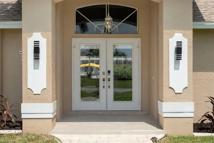 Doorway to property featuring french doors