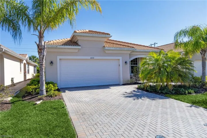 Mediterranean / spanish house featuring stucco siding, decorative driveway, a garage, and a tile roof