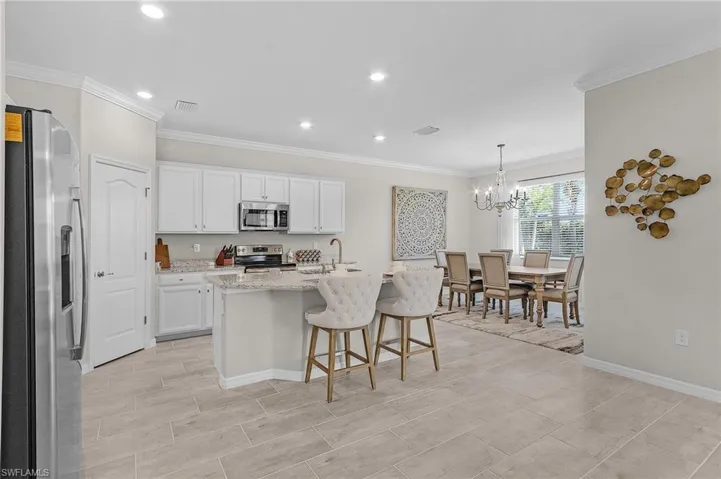 Kitchen with visible vents, white cabinets, stainless steel appliances, and a sink
