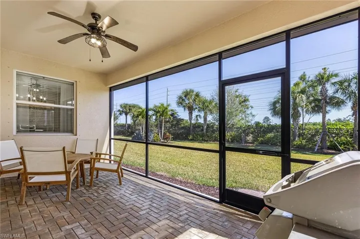 Sunroom / solarium featuring a ceiling fan