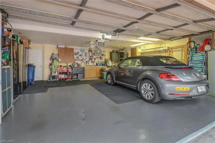 Garage featuring a workshop area and a garage door opener