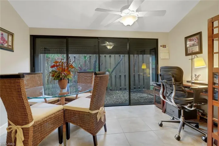 Tiled dining space featuring ceiling fan and lofted ceiling