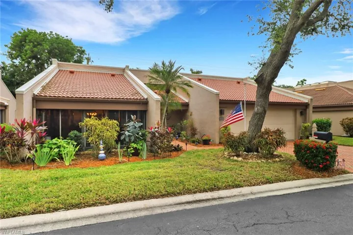 Mediterranean / spanish house with a sunroom and a front yard