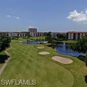 View of home's community with a yard and a water view