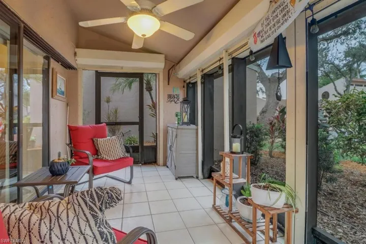 Sunroom with vaulted ceiling, ceiling fan, and plenty of natural light