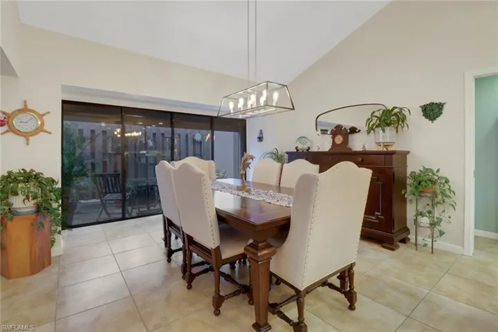 Dining room featuring lofted ceiling and light tile patterned floors