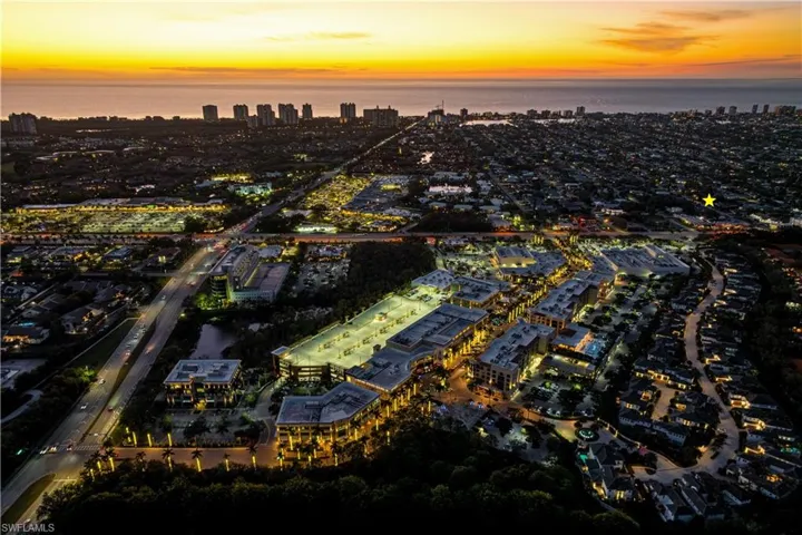 Aerial view at dusk featuring a water view