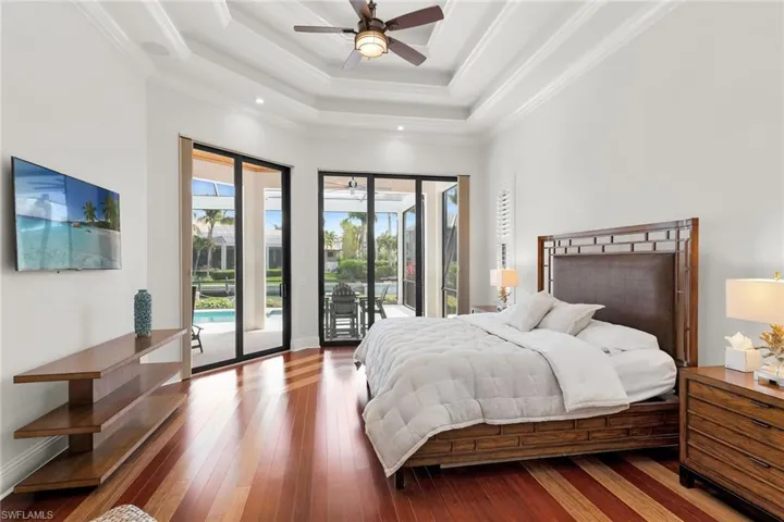 Spacious interior featuring wood-finish flooring, a coffered ceiling with recessed lighting, and a ceiling fan