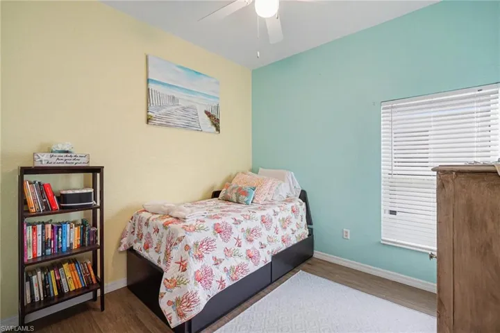 Bedroom with dark wood-type flooring and ceiling fan