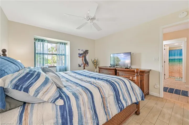 Bedroom with ceiling fan and baseboards