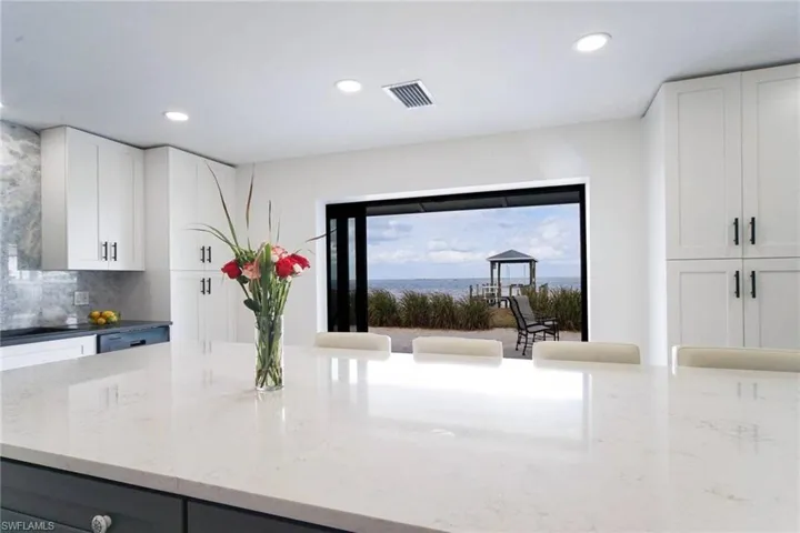 Pocketing, impact glass sliders open to the big water views! Island countertop is Corian Quartz Level 5!