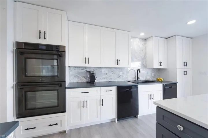 Gourmet kitchen features Double wall ovens, Countertops are Silestone Quartz in Charcoal Soapstone Suede, Double dishwashers and pantry.