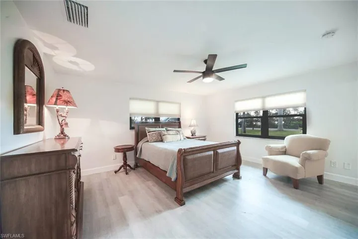 Guest bedroom that can be used as a second master with an en-suite bath, LVP flooring and views to the back bay area across the street.