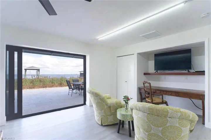 Features impact sliding glass doors leading to the travertine patio and pool deck. Offers incredible views of Matlacha Pass.
