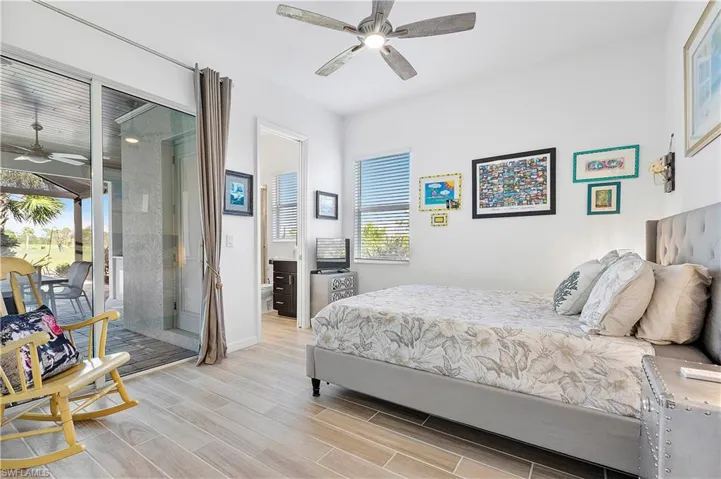 Bedroom featuring access to exterior, baseboards, a ceiling fan, and wood tiled floor