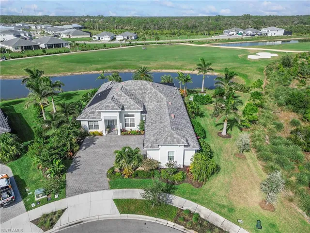Birds eye view of property featuring a water view and a residential view
