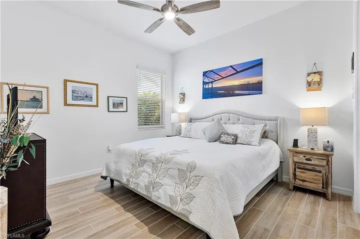 Bedroom with baseboards, a ceiling fan, and wood tiled floor