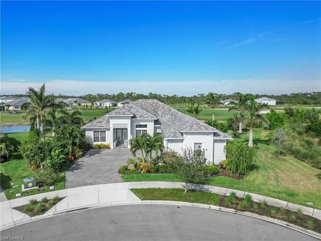 View of front facade with driveway and a front yard